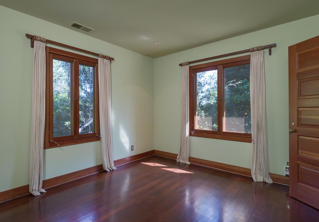 699 San Ysidro Road Montecito, CA 93108 - Photo 29 of 36 an empty room with wooden floor and windows