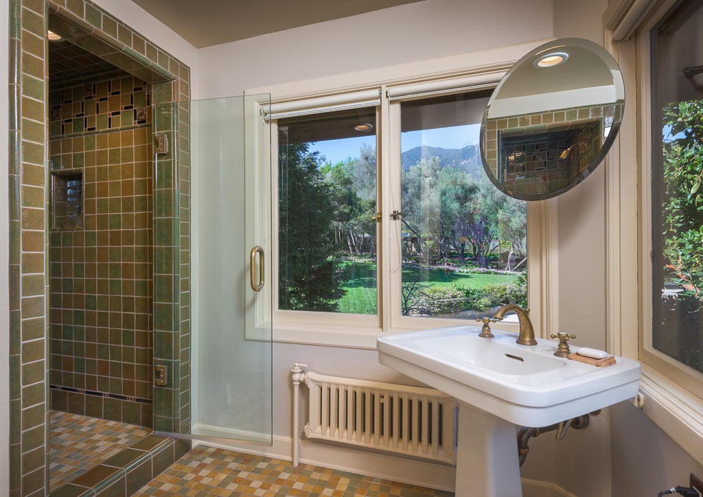 699 San Ysidro Road Montecito, CA 93108 - Photo 32 of 36 a view of a bathroom with a sink and mirror