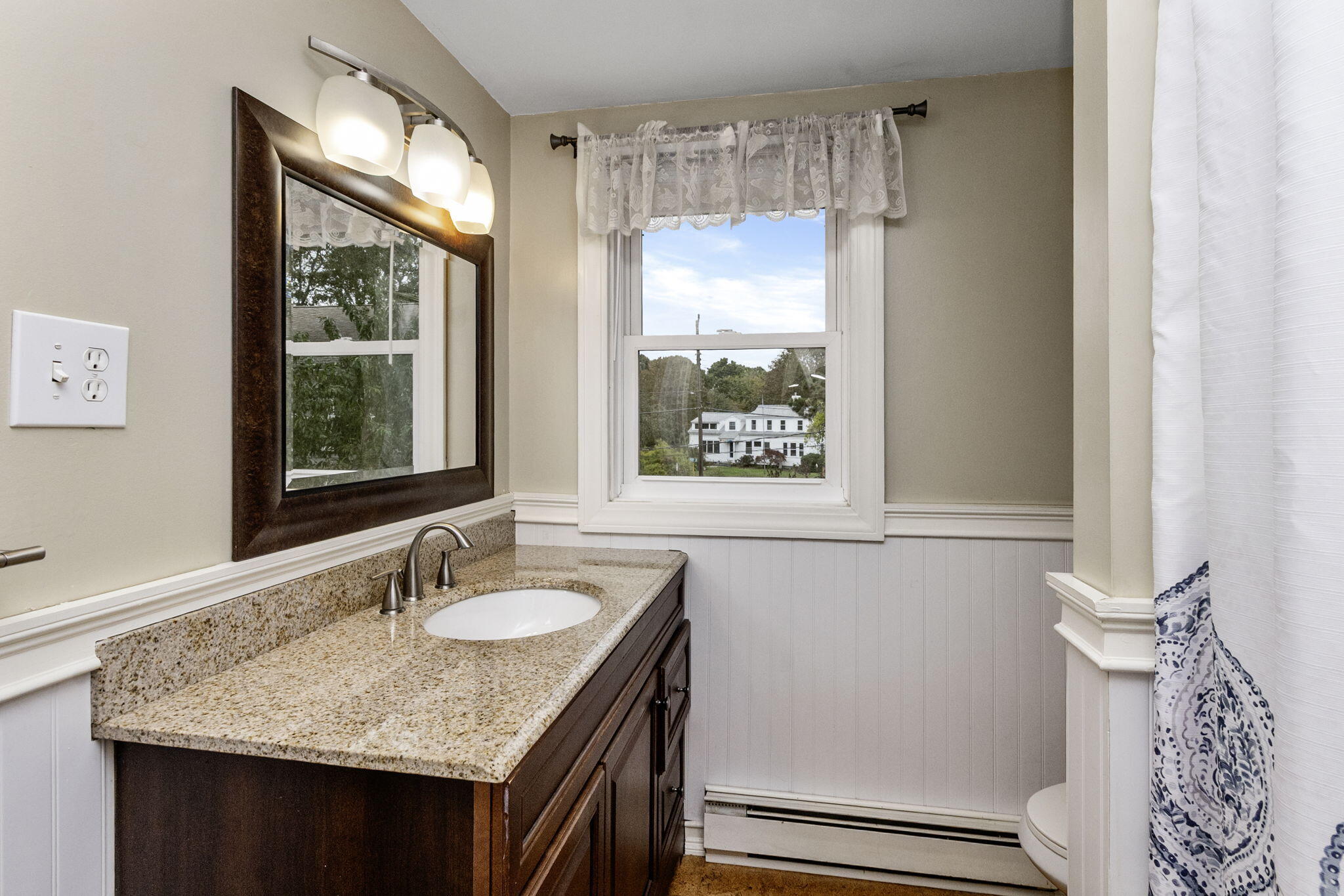 102 Sea Street Dennis Port, MA 02639 - Photo 17 of 40 a bathroom with a granite countertop sink and a window