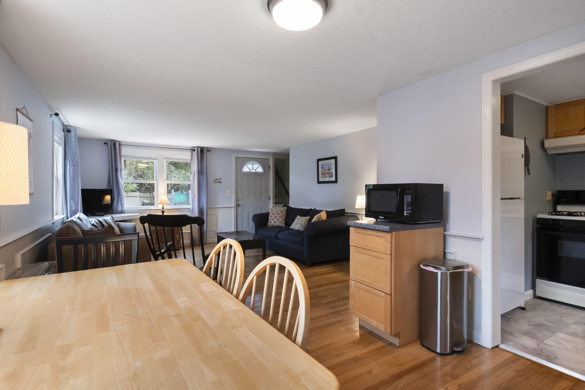 102 Sea Street Dennis Port, MA 02639 - Photo 26 of 40 a living room with furniture a flat screen tv and kitchen view