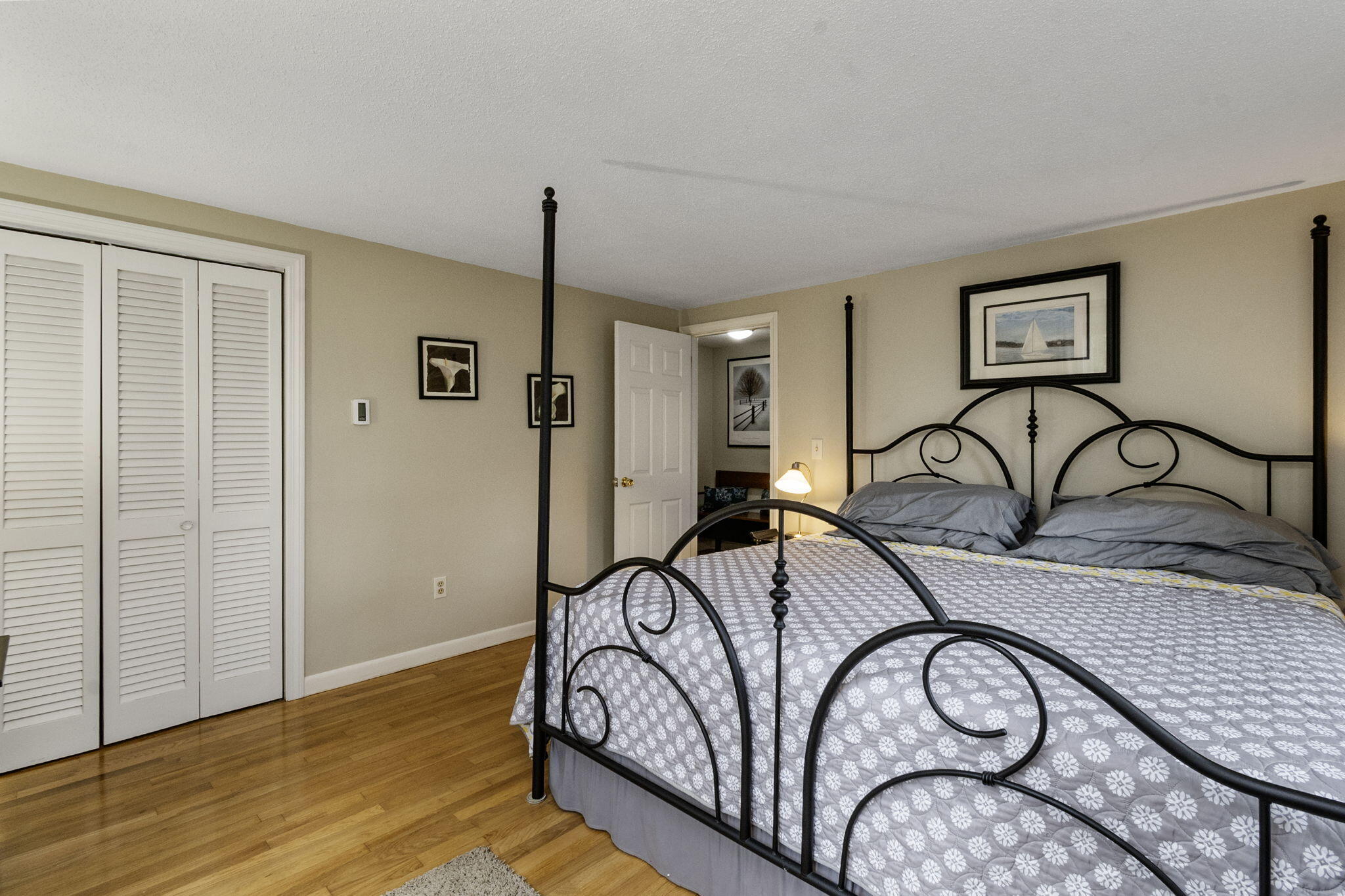 102 Sea Street Dennis Port, MA 02639 - Photo 32 of 40 a bedroom with a bed and a table with wooden floor