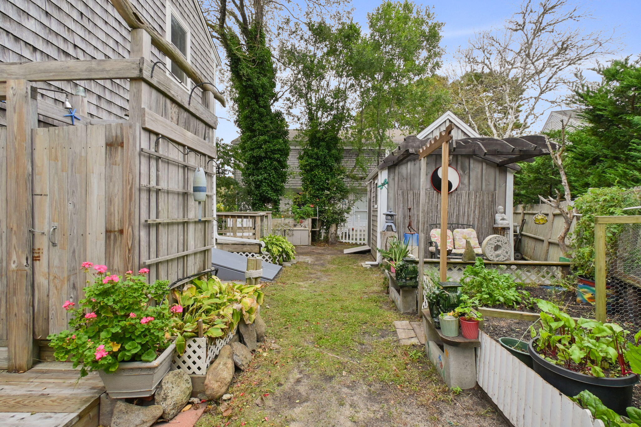 102 Sea Street Dennis Port, MA 02639 - Photo 35 of 40 a view of a chair and table in backyard of house