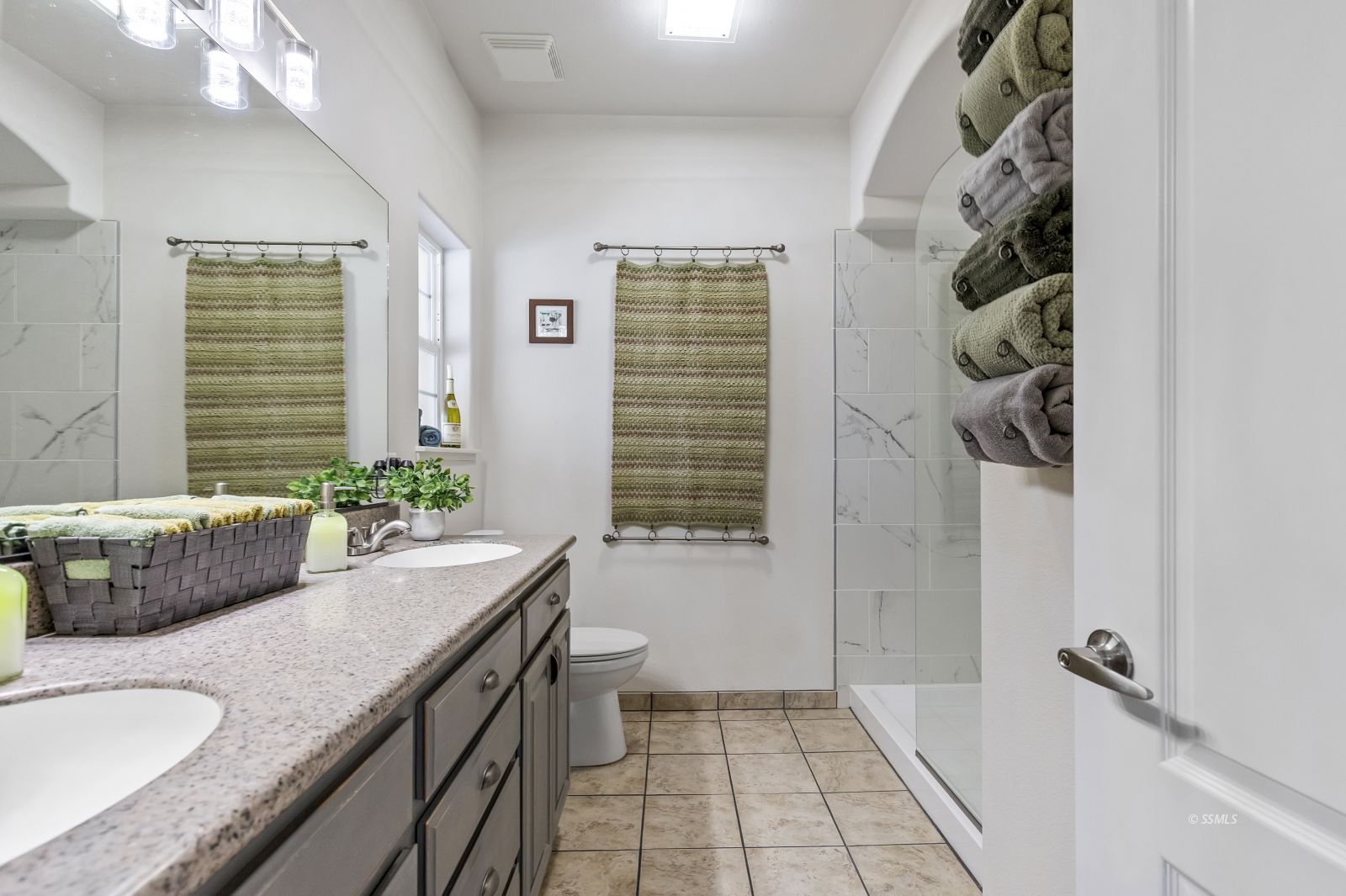 413 Acacia Street Ridgecrest, CA 93555 - Photo 19 of 34 a bathroom with a granite countertop sink a toilet a window and shower