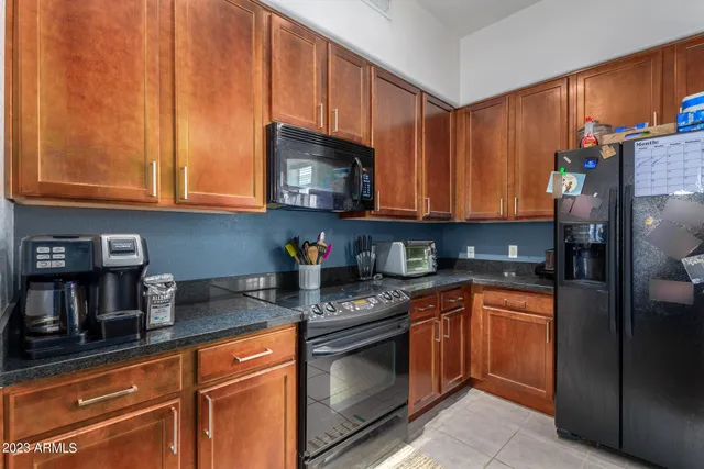 a kitchen with stainless steel appliances granite countertop a refrigerator sink and cabinets