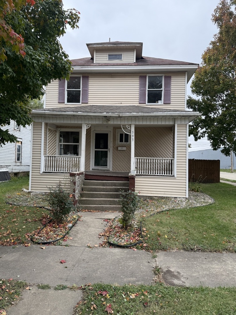 393 North 6th Avenue Kankakee, IL 60901 - Photo 2 of 11 a front view of a house with a garden