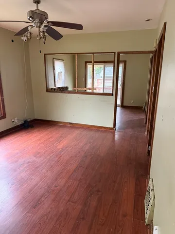 wooden floor in an empty room with a window