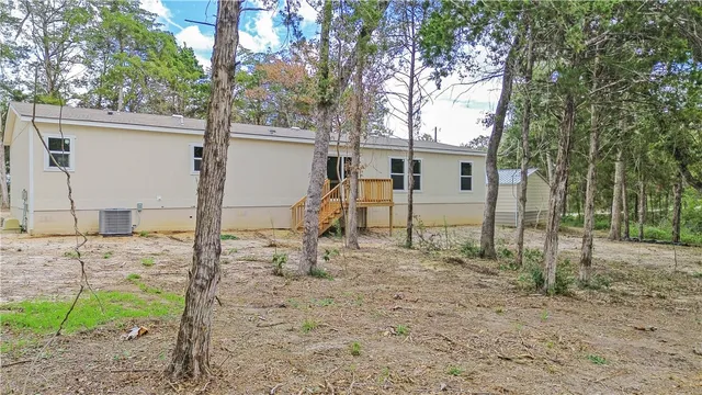 a view of a house with a backyard