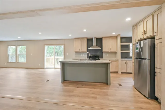 a view of a kitchen with a sink and a refrigerator