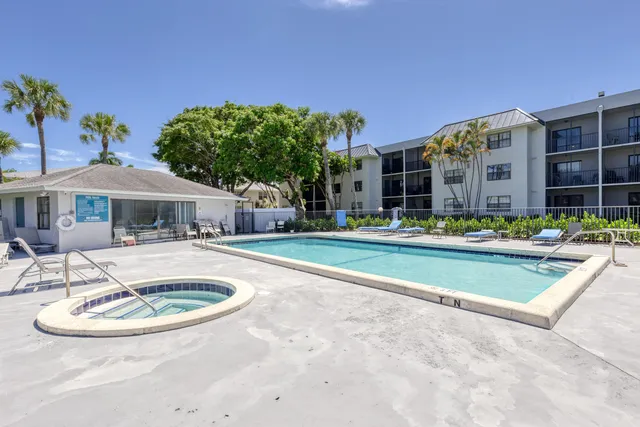 a view of a house with swimming pool and a sitting area