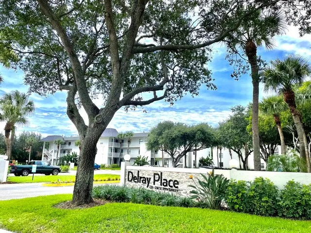 a view of an house with garden and trees