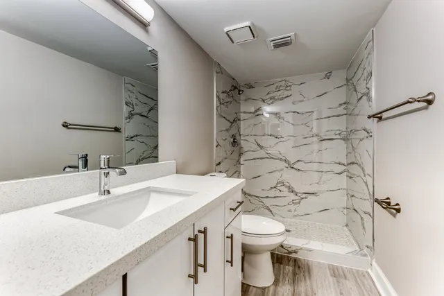 a bathroom with a sink toilet and shower