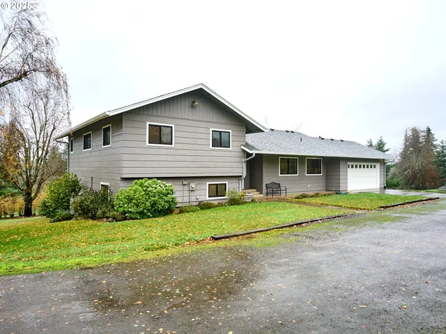 a front view of house with yard and green space
