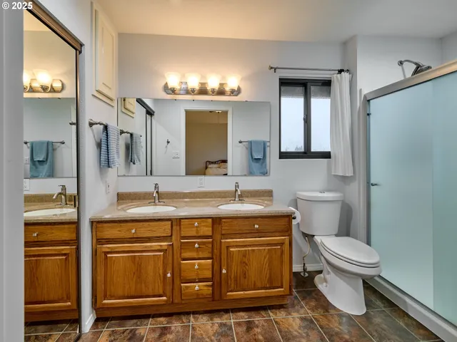 a spacious bathroom with a granite countertop toilet sink and mirror