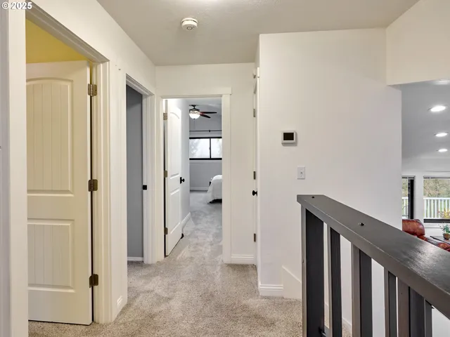 a view of a hallway with closet and wooden floor