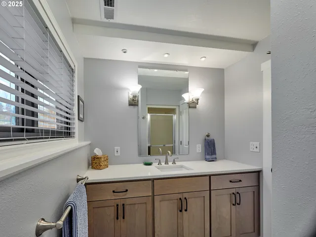 a living room with a table and paintings on the wall