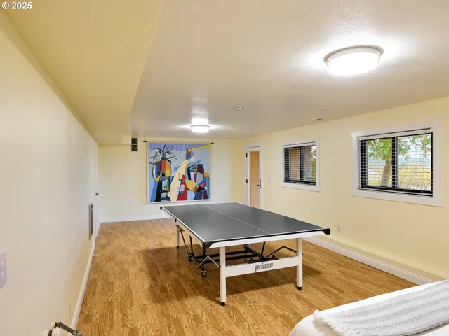 a room with furniture pool table and windows