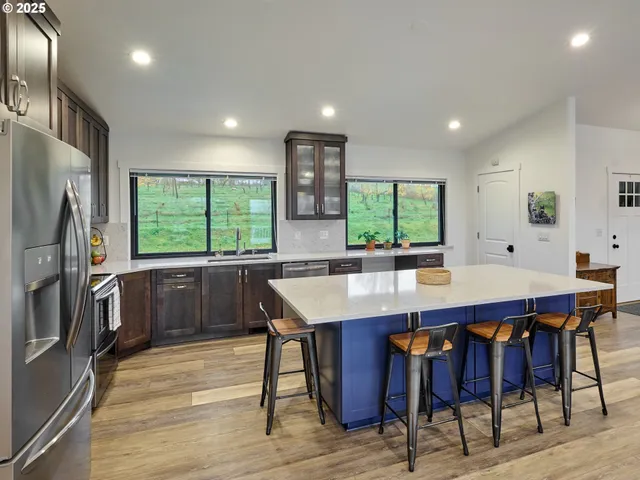 a kitchen with a table chairs refrigerator and cabinets