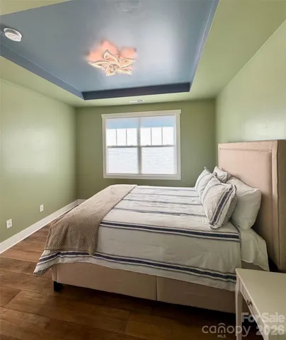an empty room with wooden floor and white walls