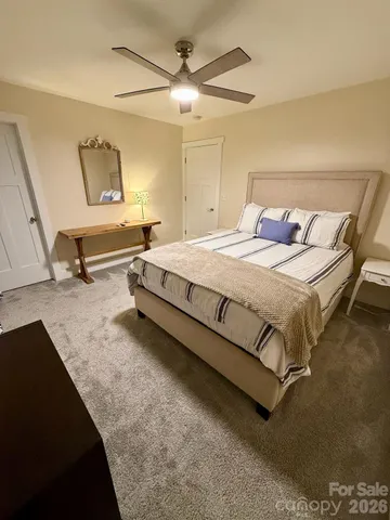 a bedroom with a bed and a refrigerator