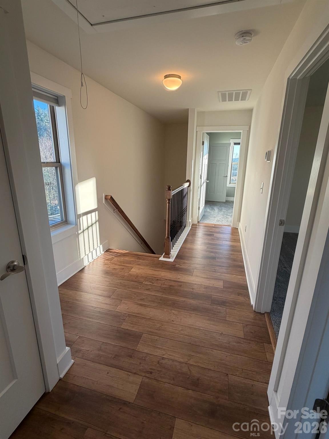 526 Cardwell Lane Fletcher, NC 28732 - Photo 24 of 37 a view of a hallway with wooden floor and staircase