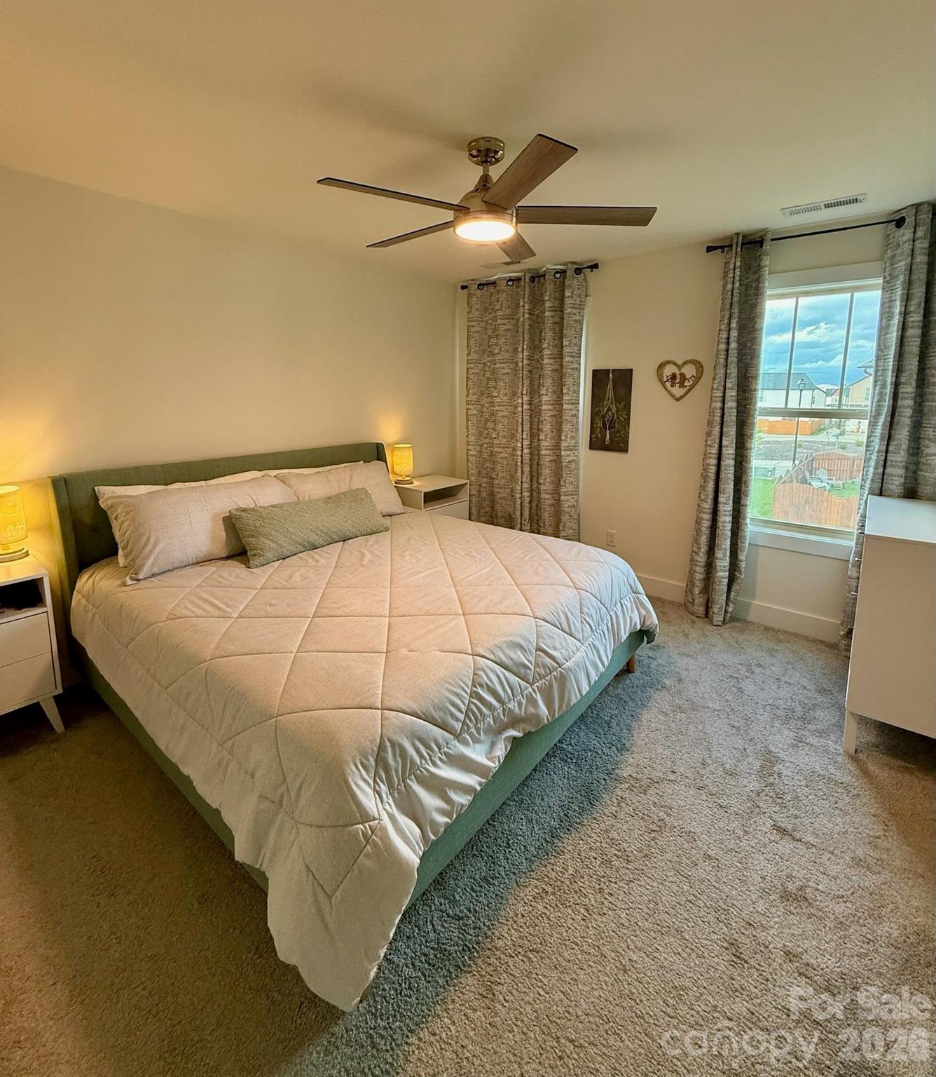 526 Cardwell Lane Fletcher, NC 28732 - Photo 26 of 37 a bedroom with a bed and a refrigerator