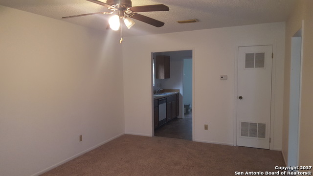 320 Station Street, Unit 101 Converse, TX 78109 - Photo 3 of 14 a view of an empty room with window and kitchen view