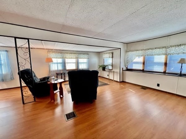 10 St James Circle Hudson, MA 01749 - Photo 5 of 14 a living room with furniture floor to ceiling window and wooden floor