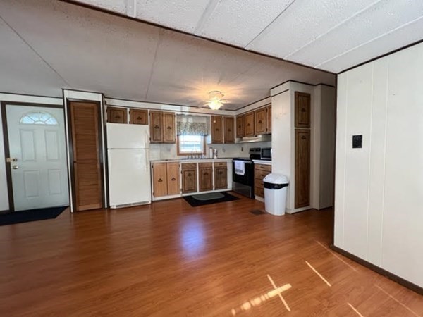 10 St James Circle Hudson, MA 01749 - Photo 6 of 14 a view of an empty room with a window and wooden floor