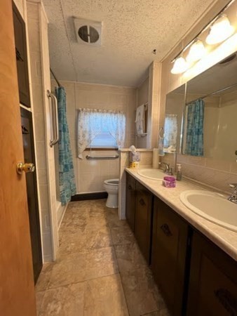 10 St James Circle Hudson, MA 01749 - Photo 8 of 14 a kitchen with a sink refrigerator and cabinets