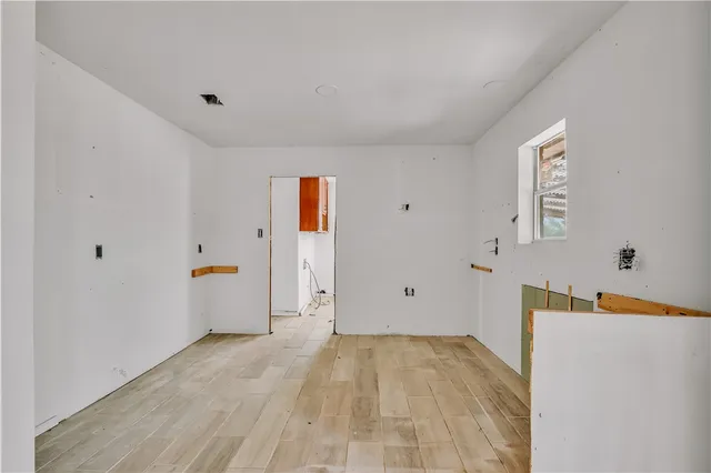 a view of a room with gym equipment and wooden floor