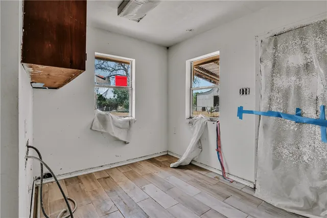a view of a hallway with wooden floor and entryway