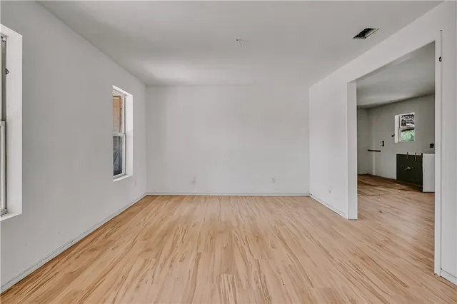 a view of a room with wooden floor and a window