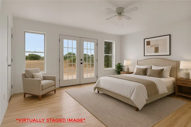 a spacious bedroom with a bed a couch and a potted plant
