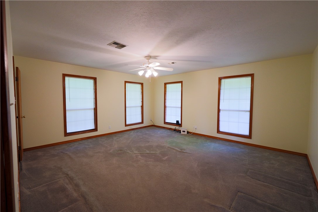 16403-16515 Macey Road Hearne, TX 77859 - Photo 32 of 46 an empty room with chandelier fan and windows