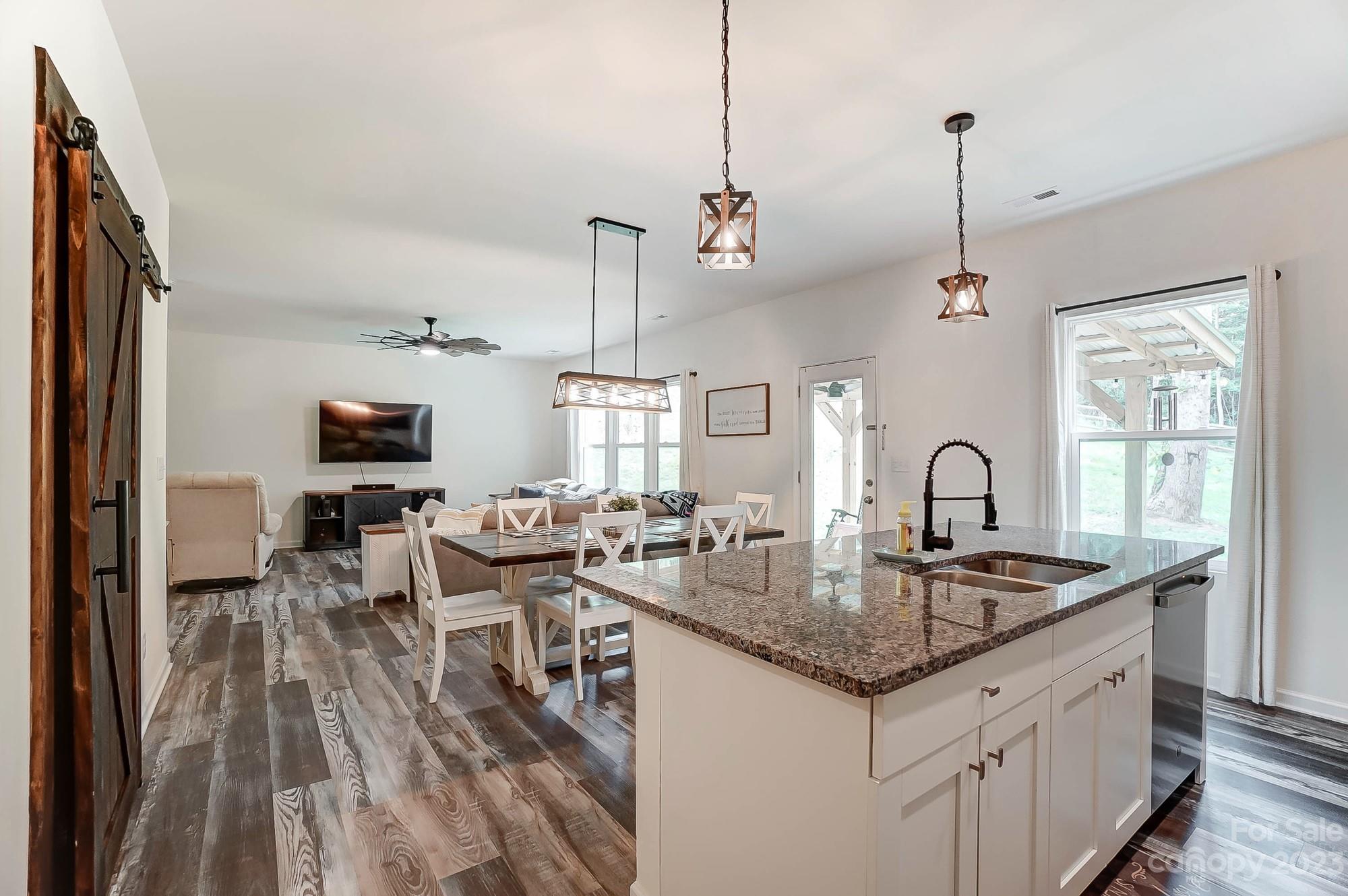 164 Mill Creek Road Iron Station, NC 28080 - Photo 16 of 48 a kitchen with granite countertop a sink a counter space appliances and cabinets