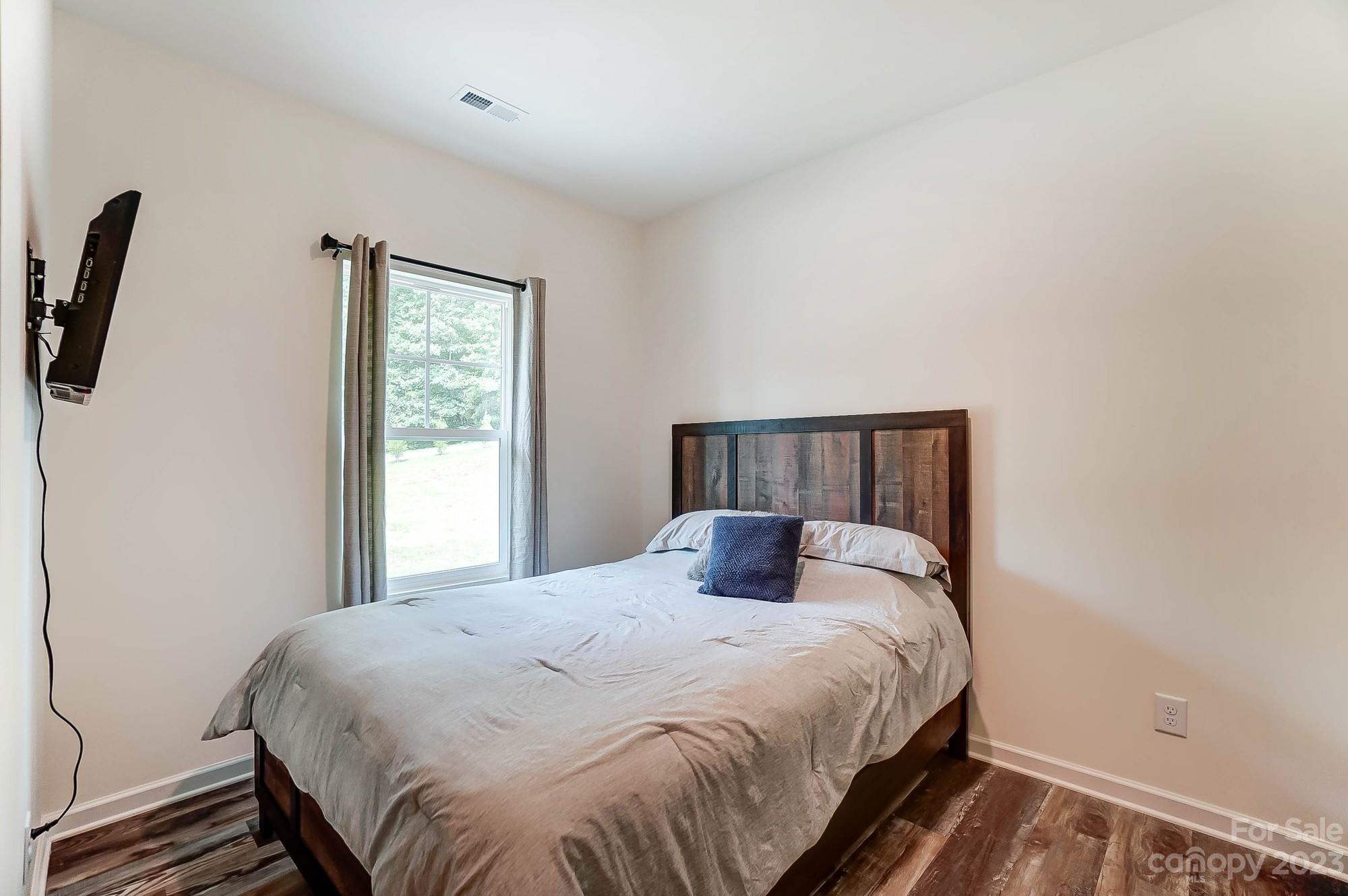 164 Mill Creek Road Iron Station, NC 28080 - Photo 19 of 48 a bedroom with a bed and a window