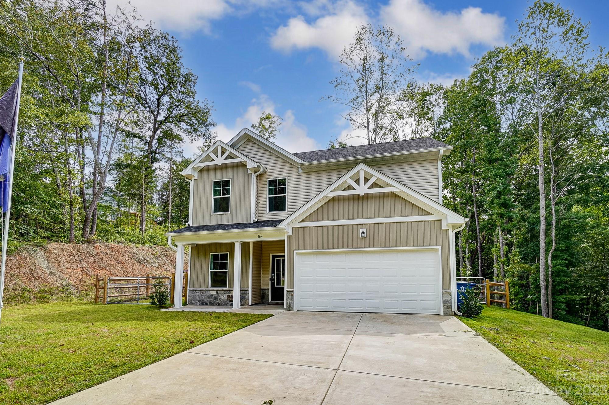 164 Mill Creek Road Iron Station, NC 28080 - Photo 2 of 48 a front view of a house with a garden