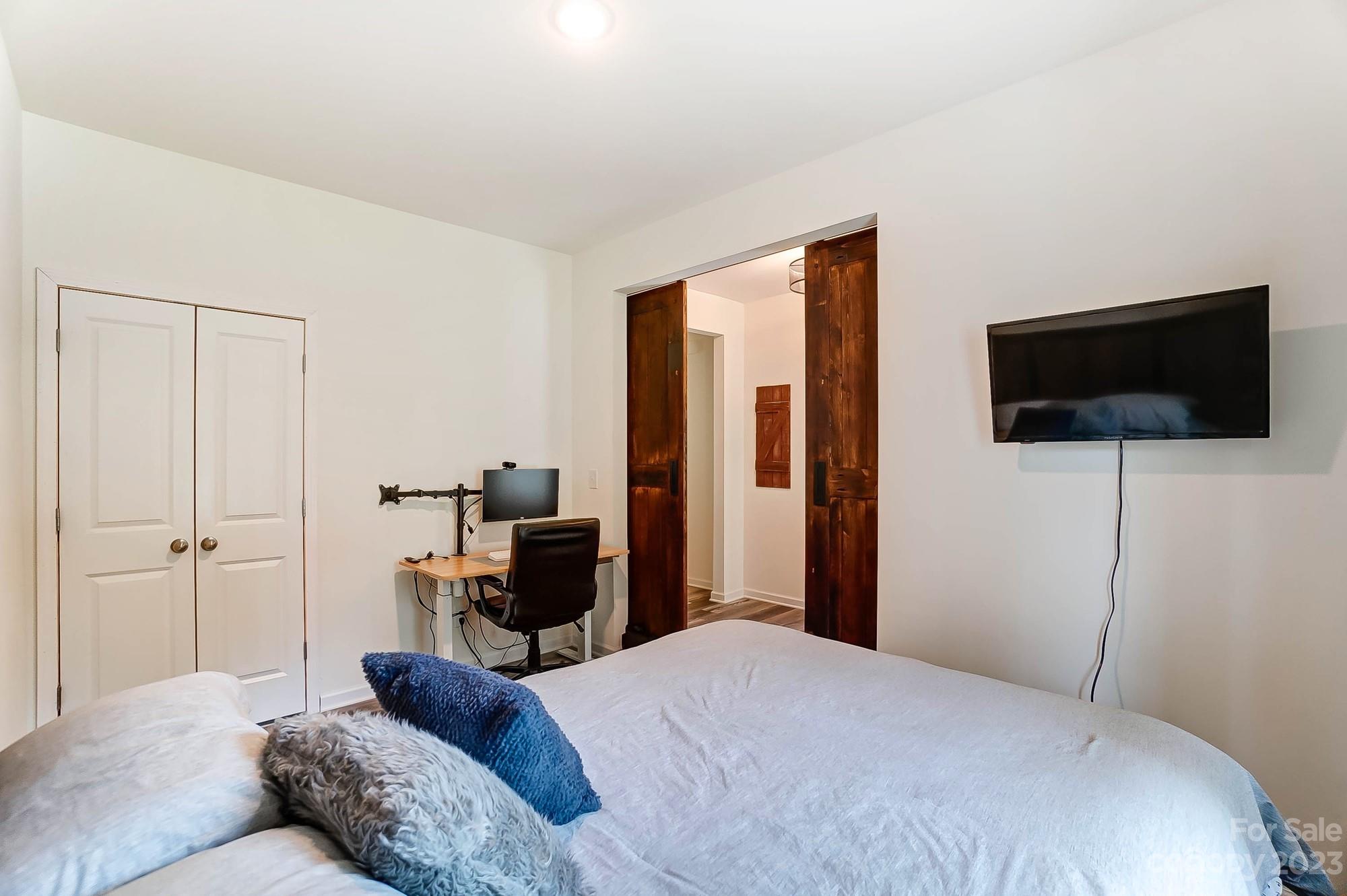 164 Mill Creek Road Iron Station, NC 28080 - Photo 21 of 48 a bedroom with a bed and a flat screen tv