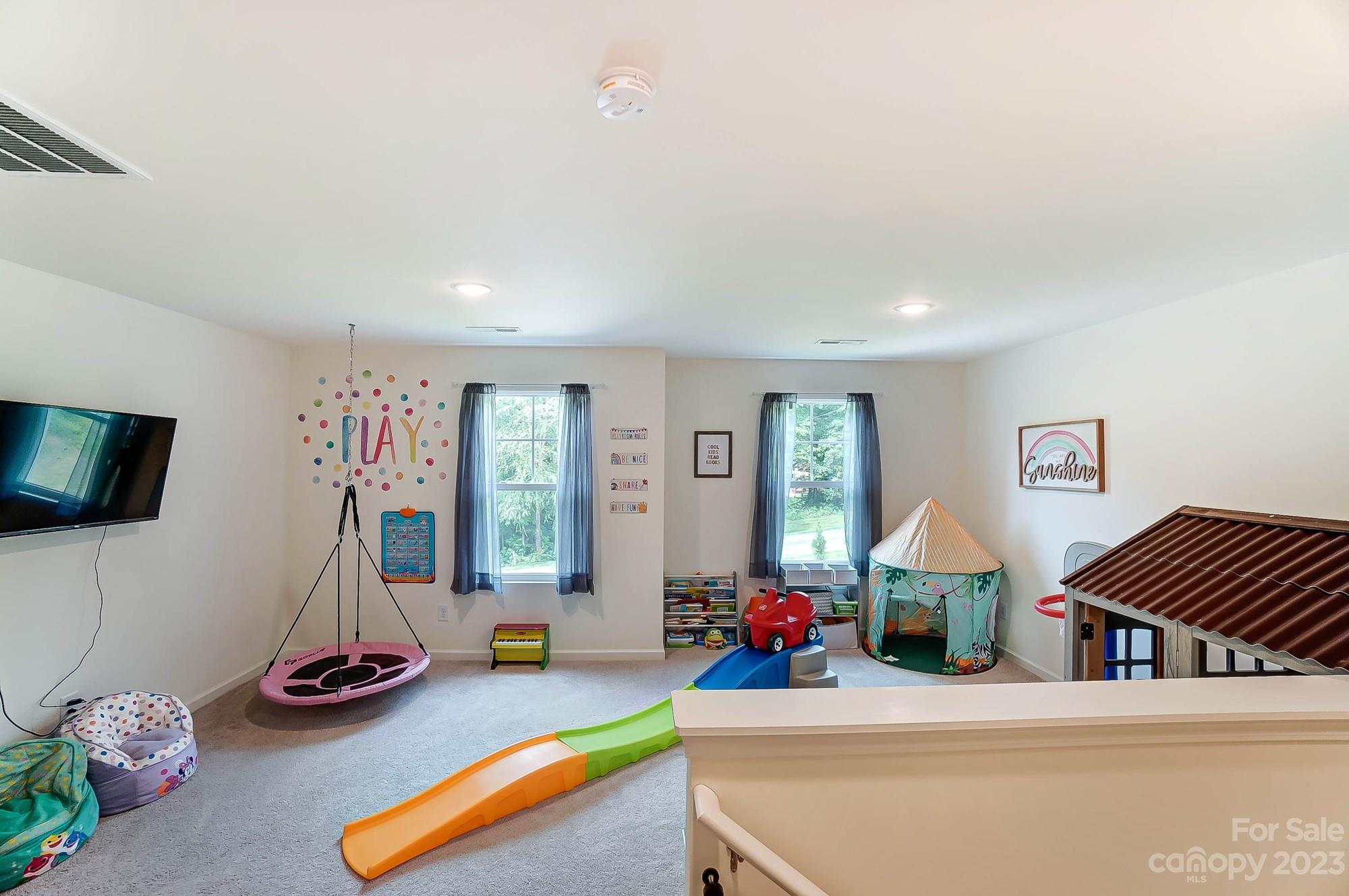 164 Mill Creek Road Iron Station, NC 28080 - Photo 25 of 48 a bedroom with furniture and a flat screen tv