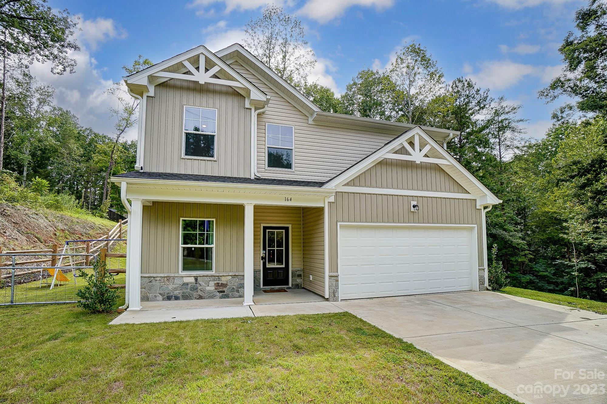 164 Mill Creek Road Iron Station, NC 28080 - Photo 3 of 48 a front view of a house with a yard and garage