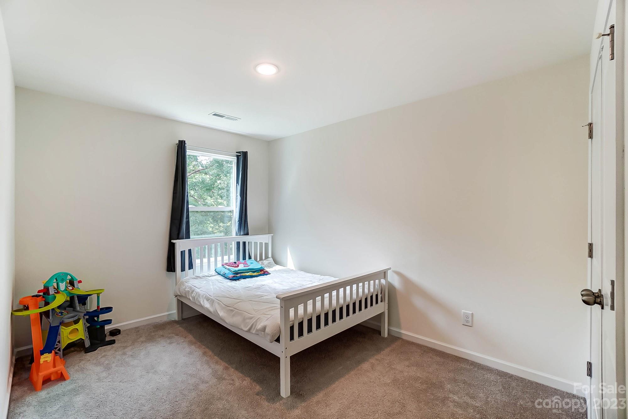164 Mill Creek Road Iron Station, NC 28080 - Photo 35 of 48 a bedroom with a bed and a window
