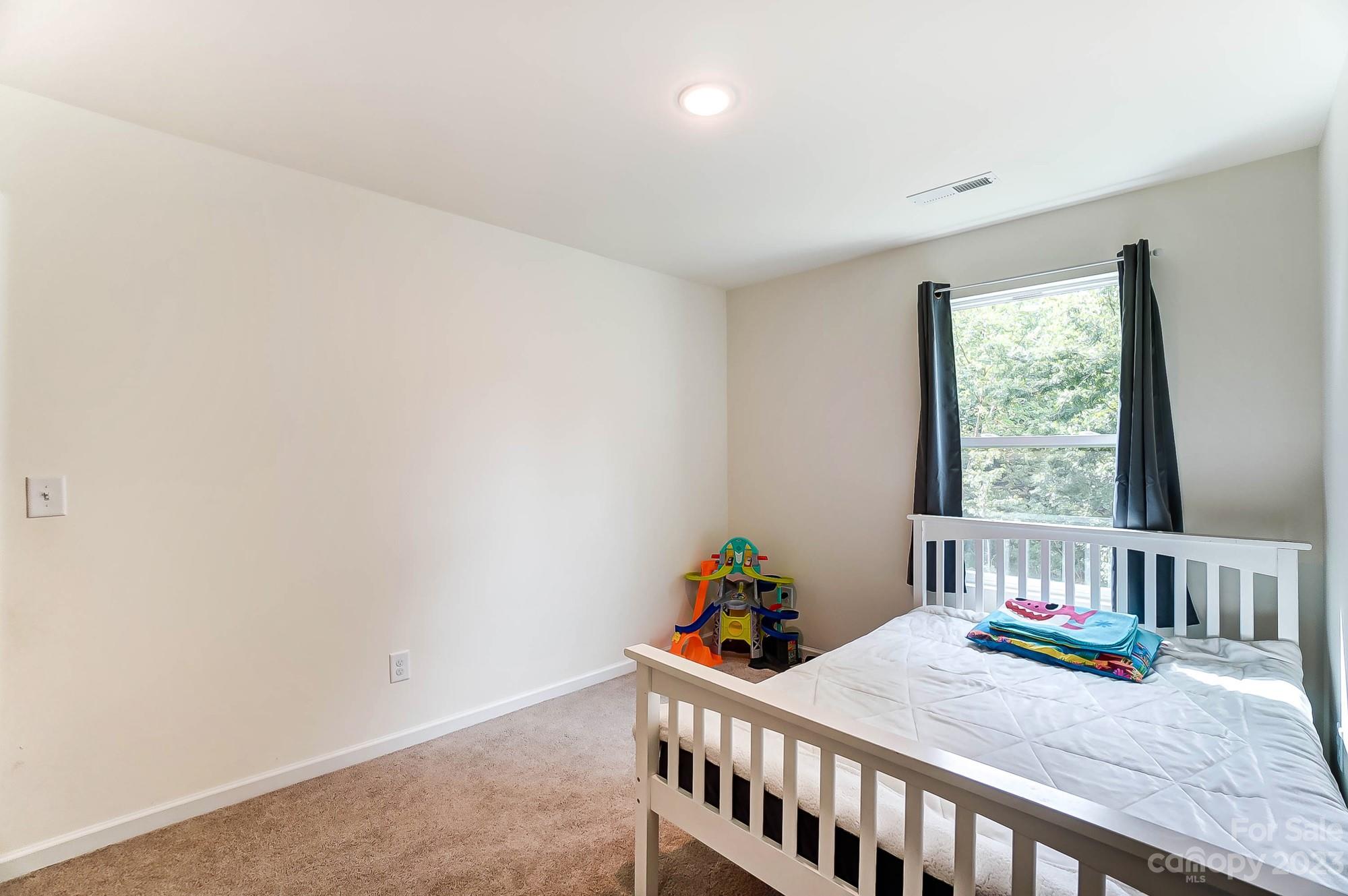 164 Mill Creek Road Iron Station, NC 28080 - Photo 36 of 48 a bedroom with furniture and window