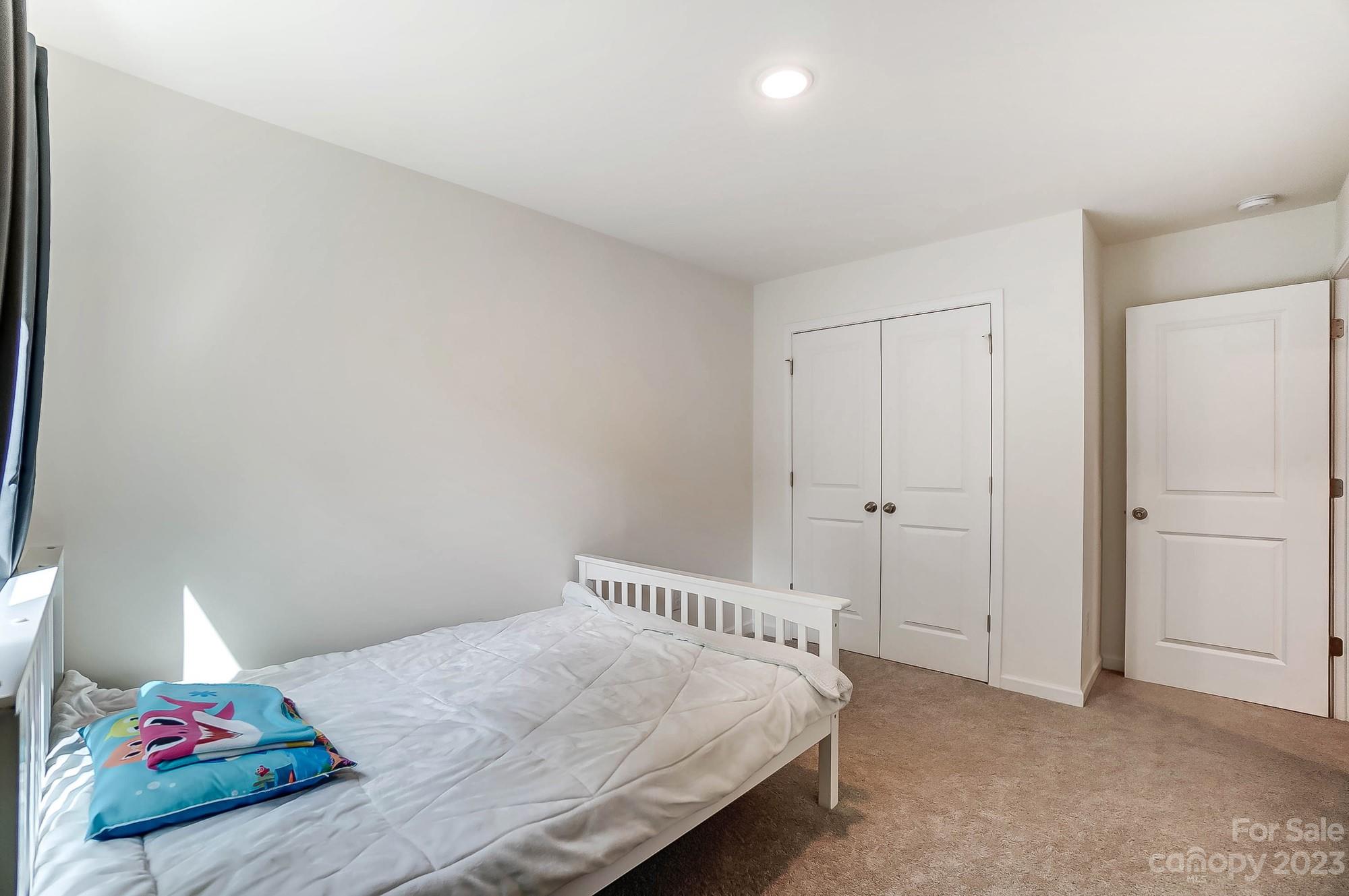 164 Mill Creek Road Iron Station, NC 28080 - Photo 37 of 48 a bedroom with a bed and a cabinets