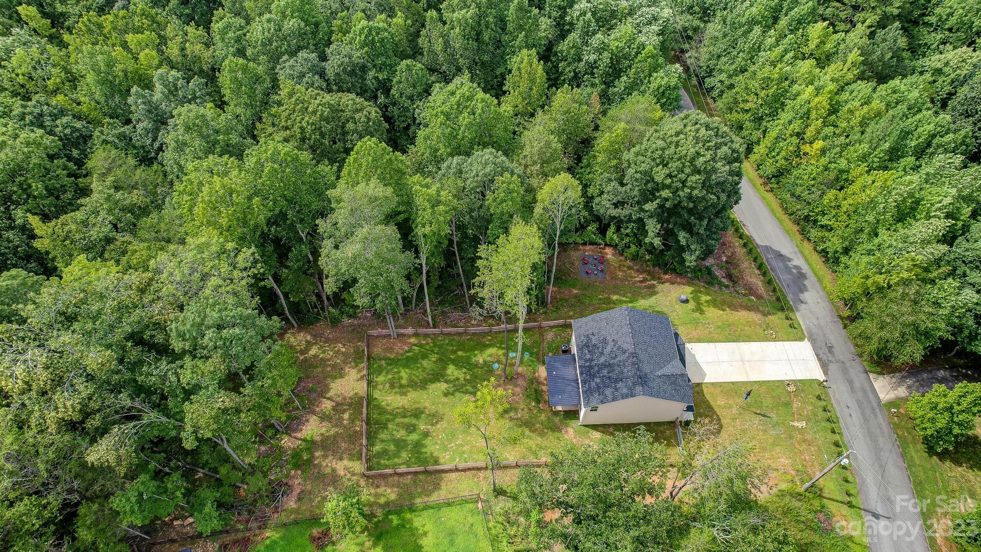 164 Mill Creek Road Iron Station, NC 28080 - Photo 5 of 48 a backyard of a house with outdoor seating and plants