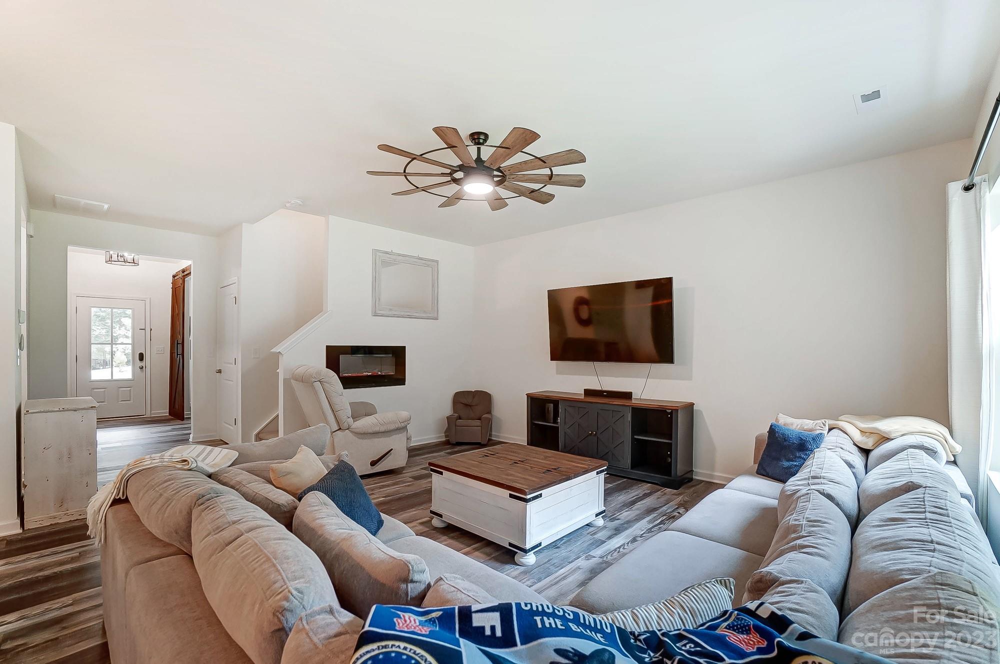 164 Mill Creek Road Iron Station, NC 28080 - Photo 8 of 48 a living room with furniture a flat screen tv and a lamp