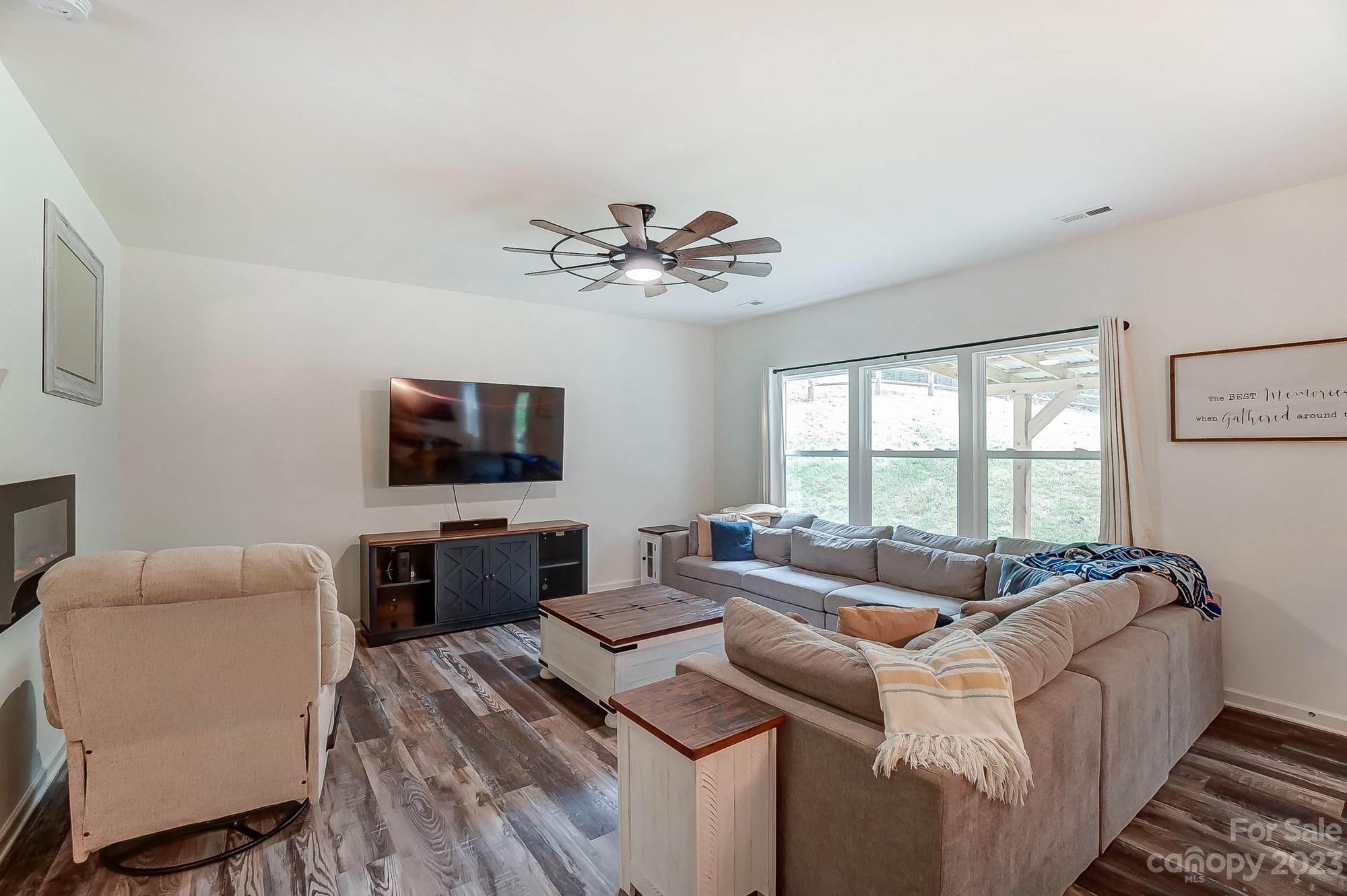 164 Mill Creek Road Iron Station, NC 28080 - Photo 9 of 48 a living room with furniture and a flat screen tv