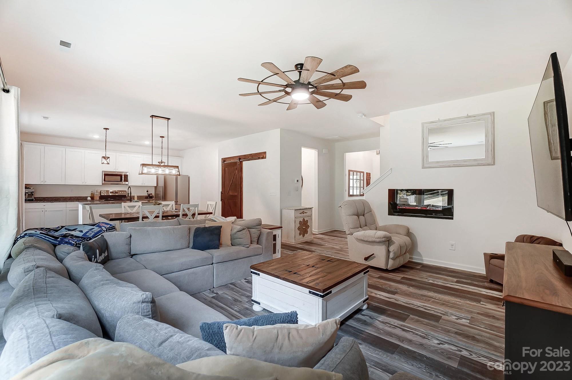 164 Mill Creek Road Iron Station, NC 28080 - Photo 10 of 48 a living room with furniture kitchen view and a chandelier