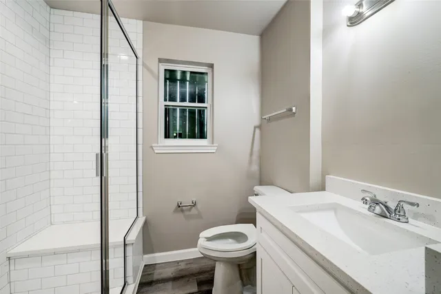 a bathroom with a sink toilet and shower