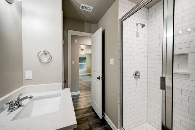 a bathroom with a tub sink and shower