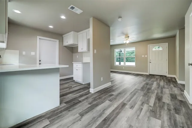 a view of kitchen with wooden floor and electronic appliances